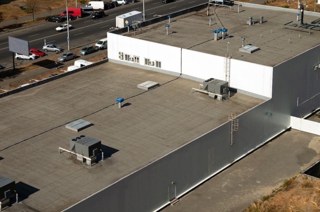 View of the roof of a commercial building in the middle of the city.