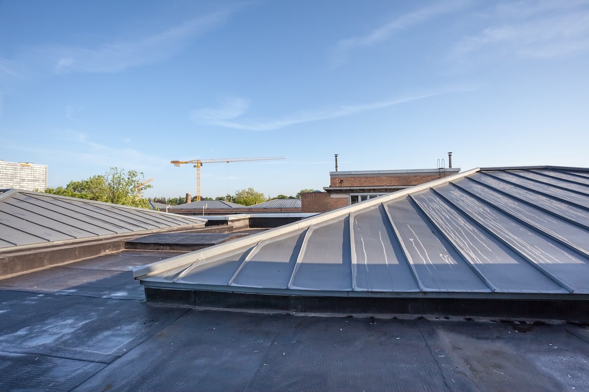 on a high building in the city there is cooling on a flat roof