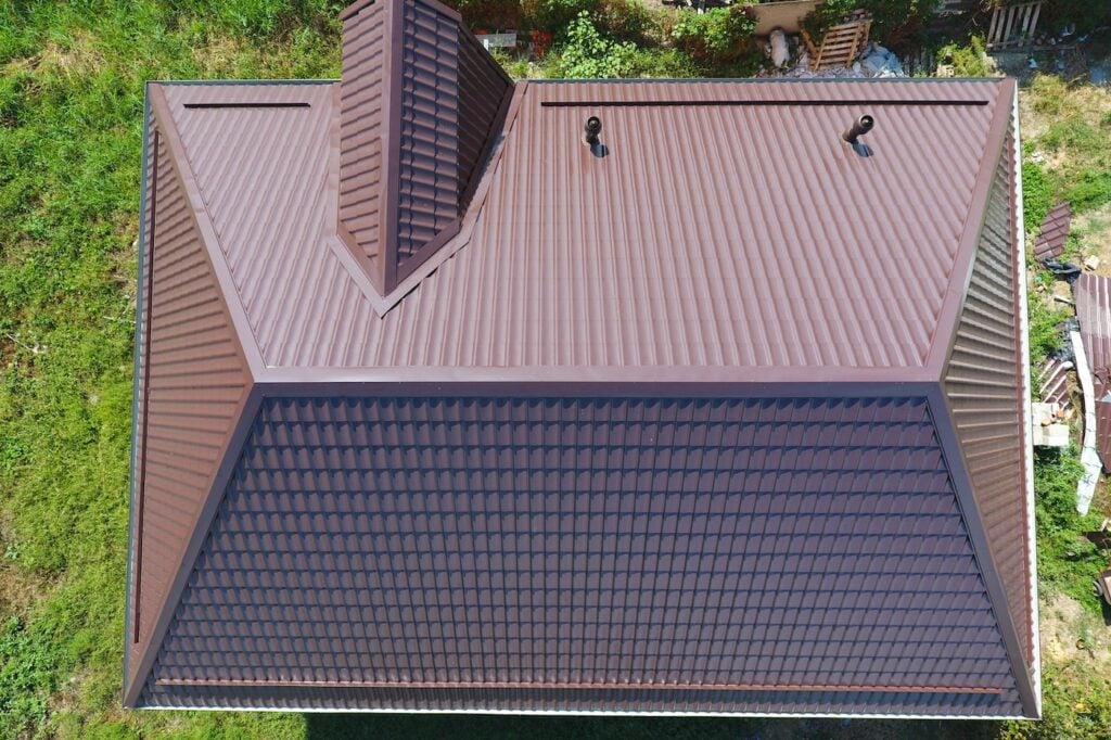 A view from above on the roof of the house. The roof of corrugated sheet. Roofing of metal profile wavy shape