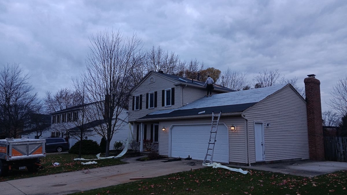 Roof repair services at dusk