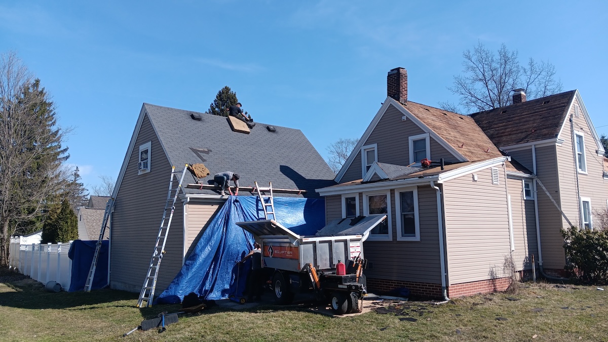 Buckeye employee tarping roof