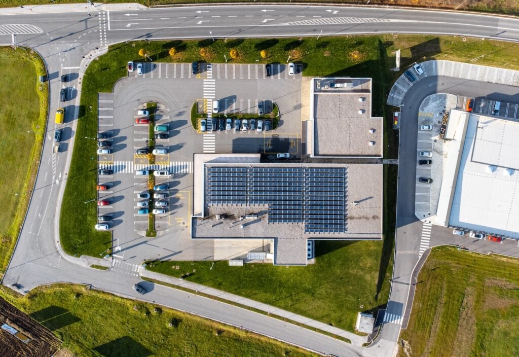 Array of solar panels on the roof of a commercial building top down