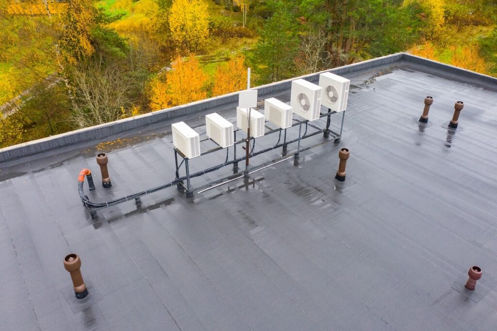 Flat roof with waterproofing Concept housetop covering with waterproofing. Air conditioners on flat roof. Flat roof is covered with waterproofing material. housetop of a large building from a height