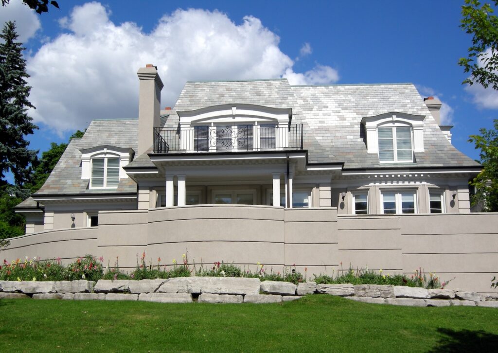 House on hill with retaining wall and composite shingles