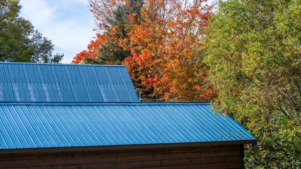 A blue metal roof in the fall colors