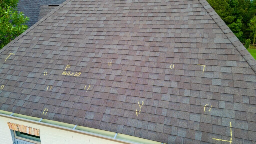 Roof with hail damage and marking from hail insurance inspection