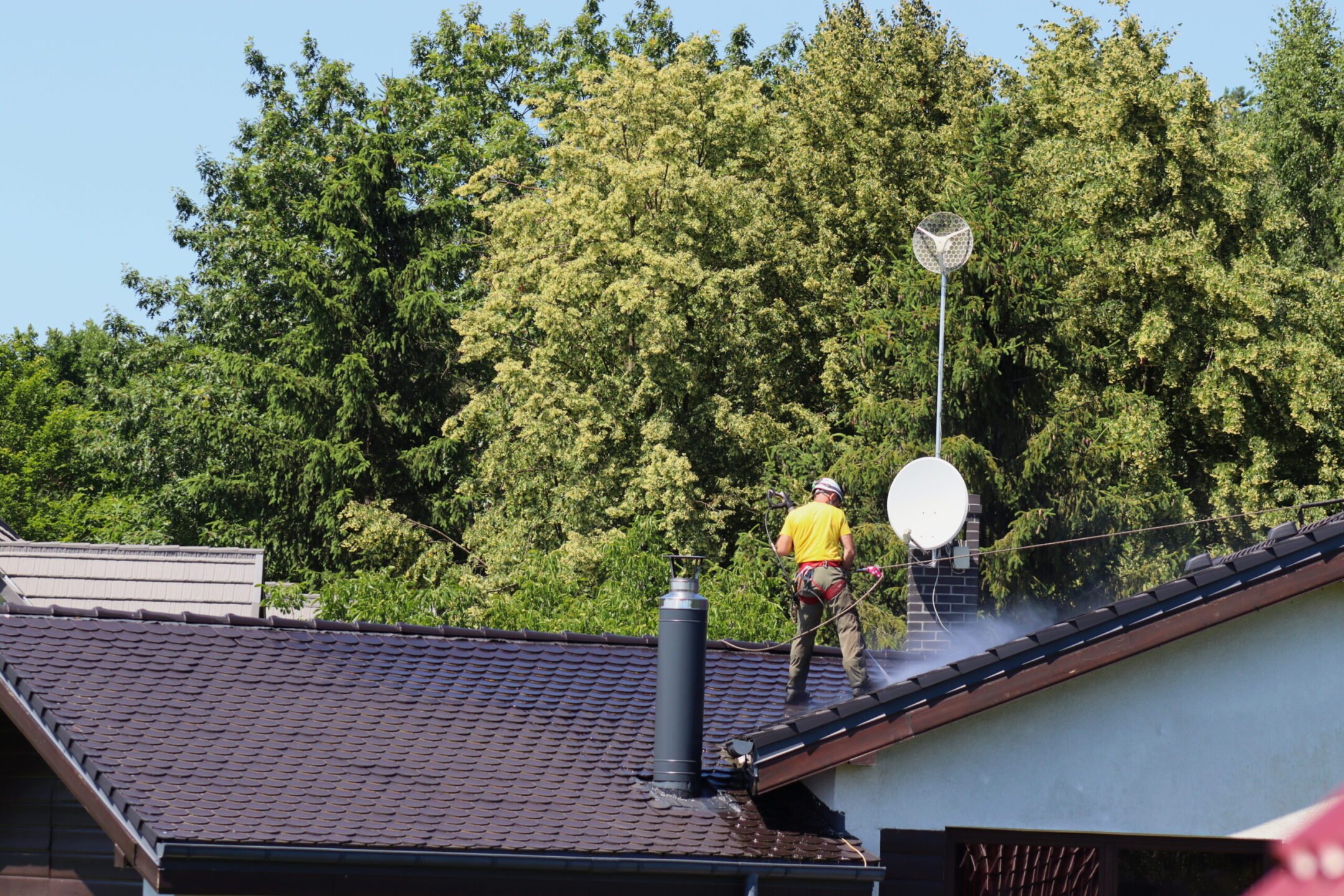Roof washing with a pressure washer