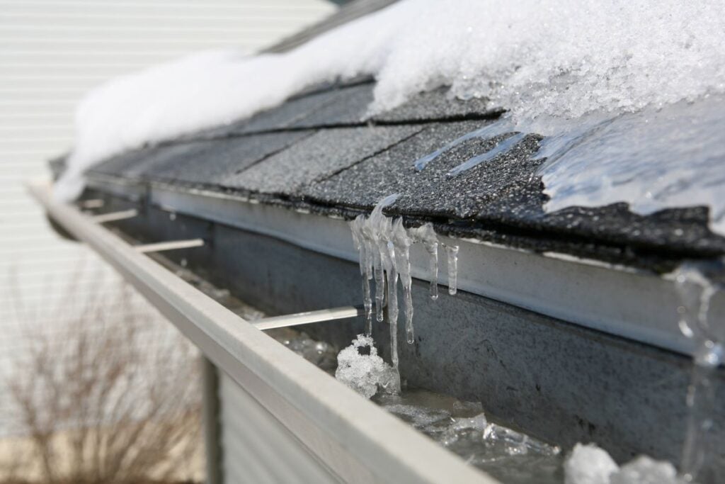 ice and snow on top of roof and water system