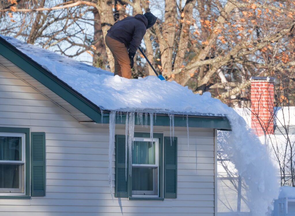 ice dam removal parma heights oh worker on top of roof