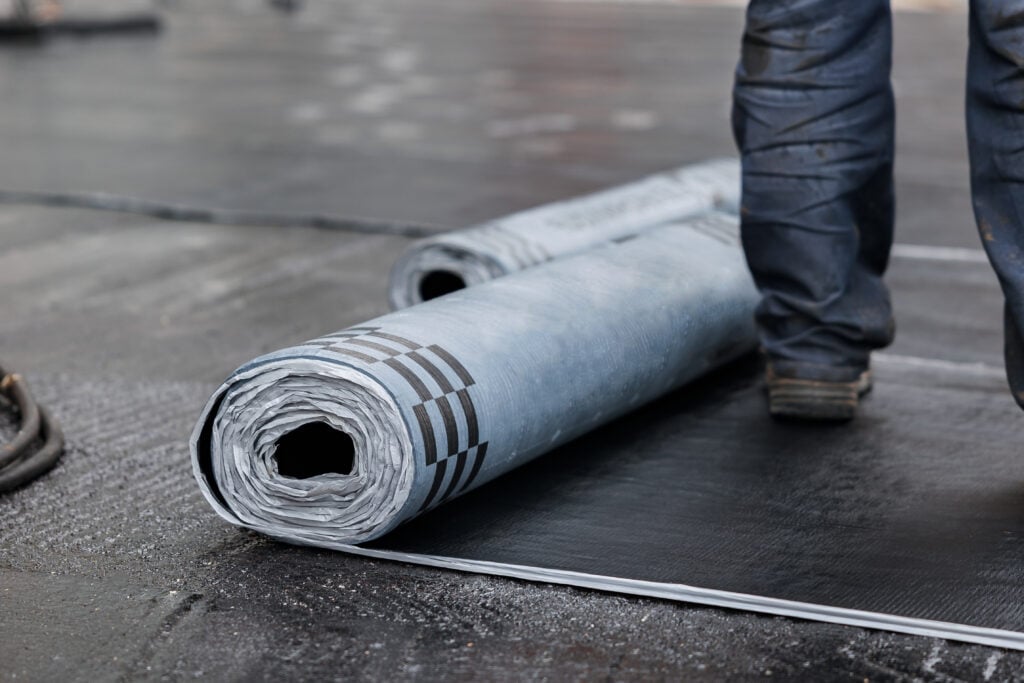 Closeup of Rolls of new black roofing felt or bitumen.
