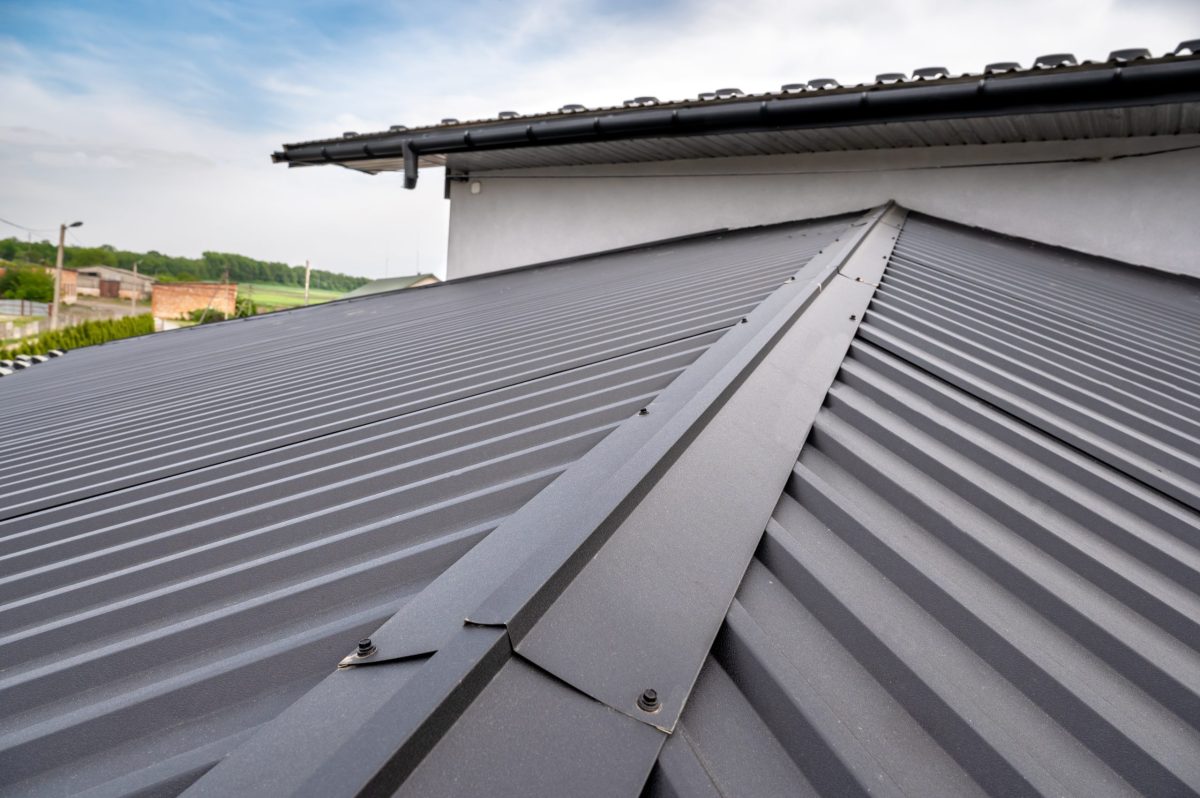 corrugated metal roofing Gutter system for a metal roof. Holder gutter drainage system on the roof.